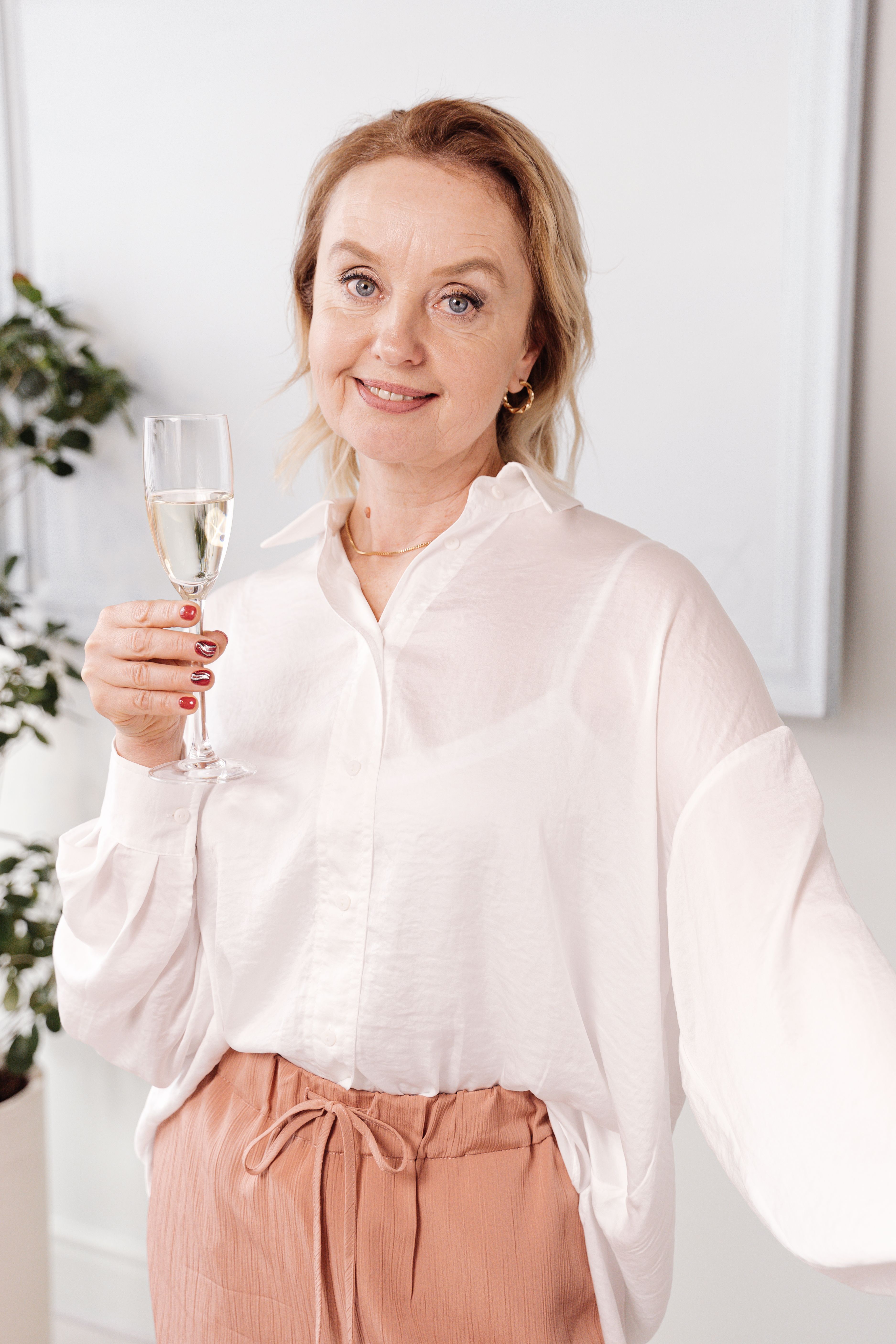 A Woman in White Top Holding a Glass of Wine · Free Stock Photo