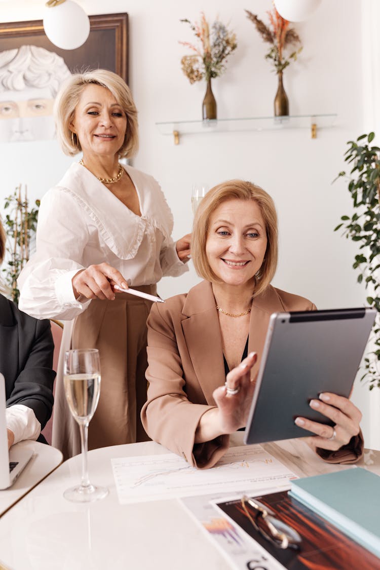 Women Looking At The Screen Of A Tablet