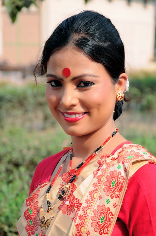 Close-Up Shot of a Pretty Woman in Red Saree Smiling