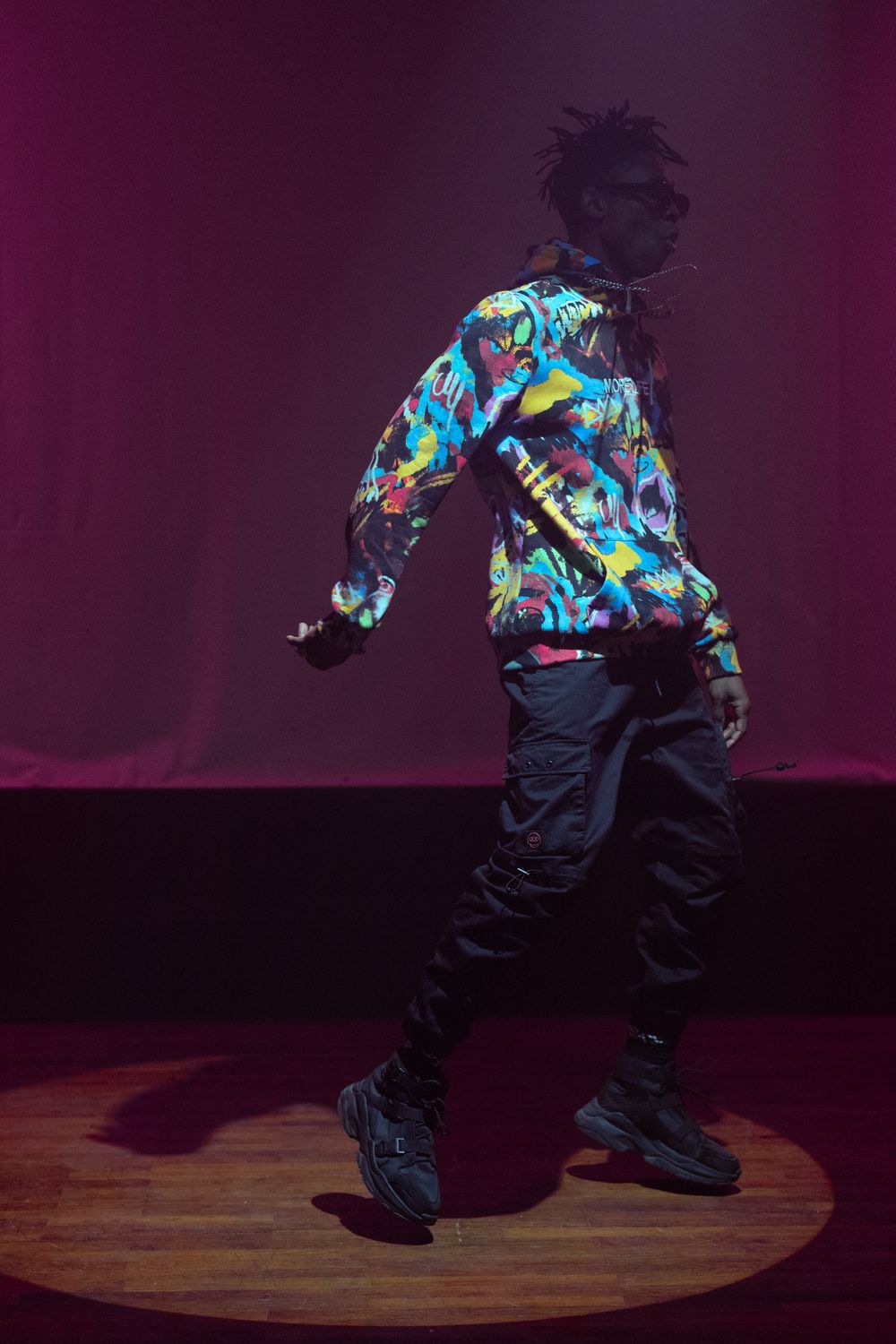 Guy Jumping While Rapping Rapper in Hoodie Jumping on Stage · Free Stock Photo