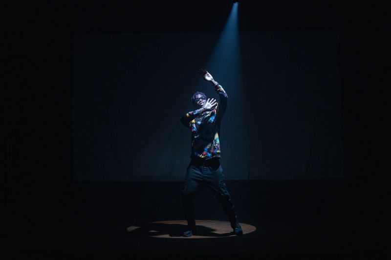 Hip-hop dancer under a spotlight