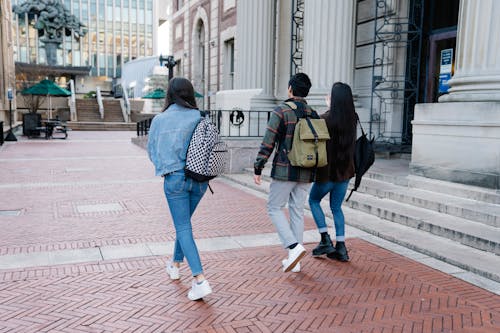 Group of People Walking on a Sidewalk