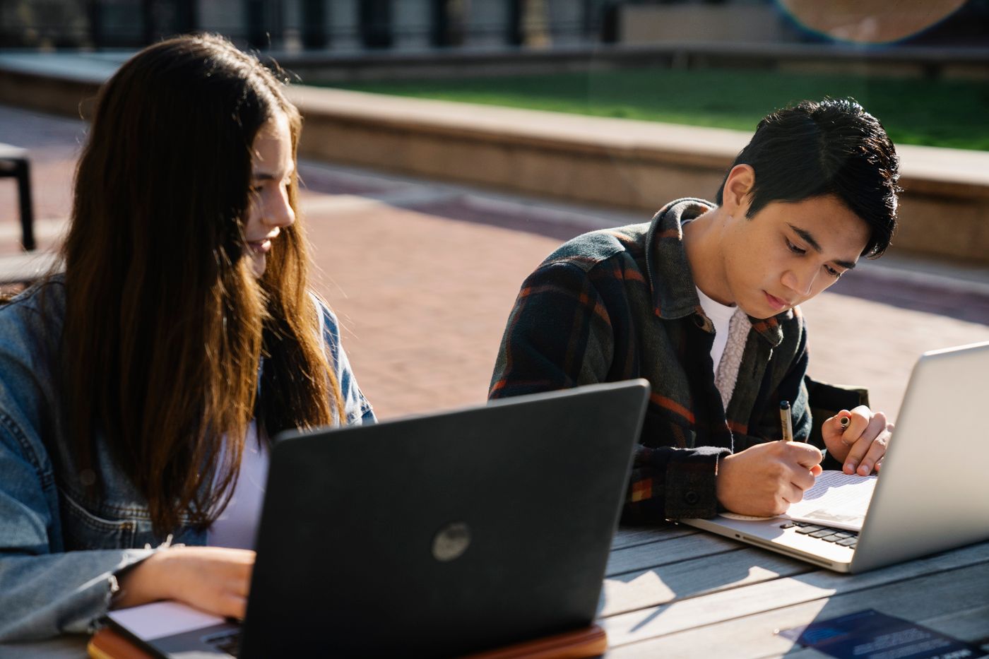 Students working on an application with laptops and notes