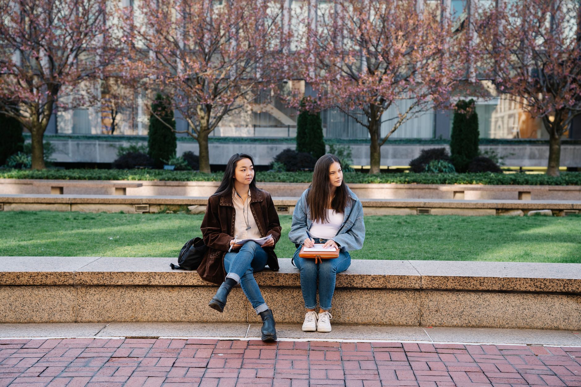 Two young women taking a quiet study and wellbeing break outdoors