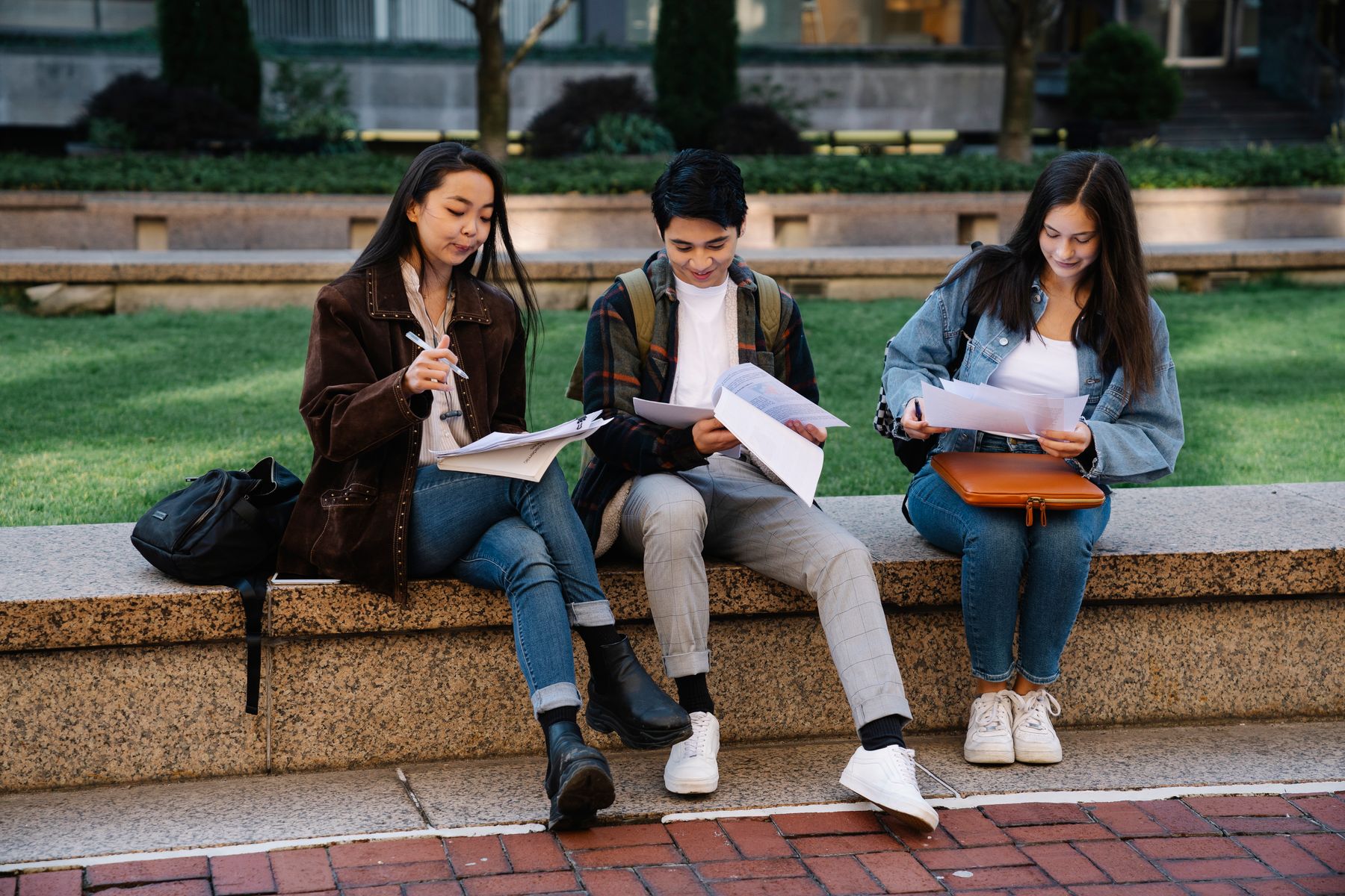 International students reviewing documents on campus