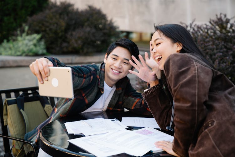 A Man And A Woman Using An Ipad