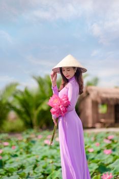 Woman in Purple Ao Dai in Field of Pink Flowers