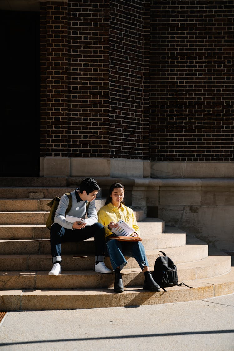 Students Sitting On Steps And Studying