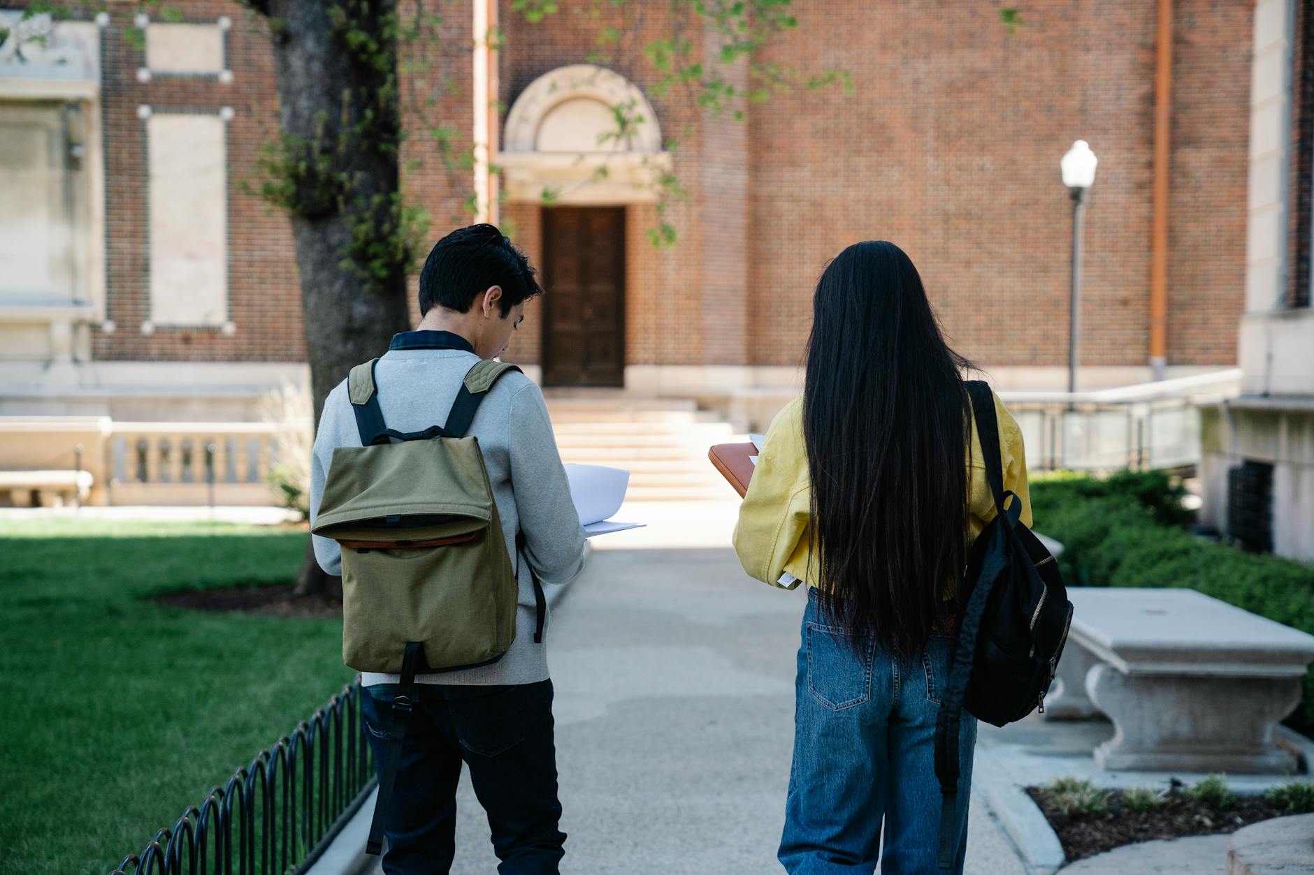 Student reviewing university prospectus materials on a laptop