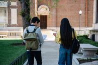 Man and Woman Walking on Sidewalk