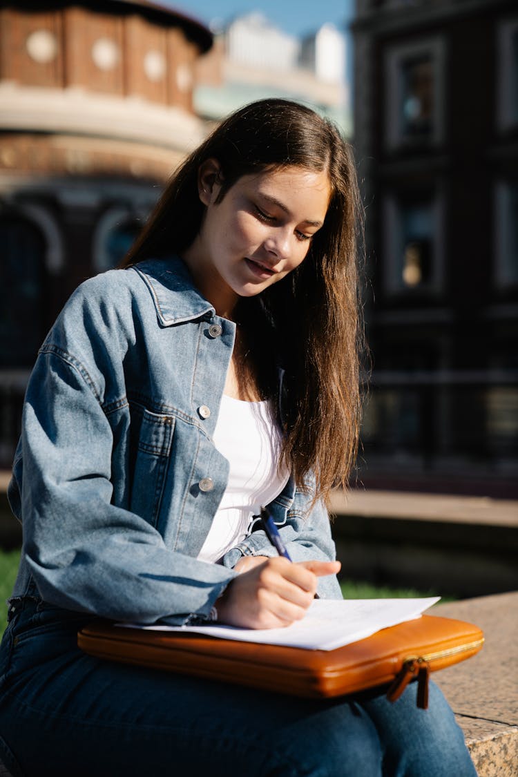 Teenage Girl Sitting Outdoors Sketching