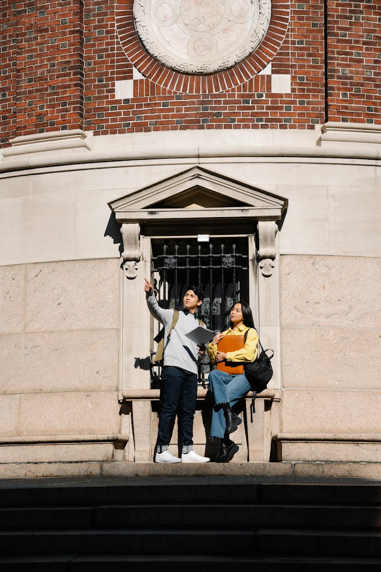 Photo Of A Man In A Gray Sweatshirt Asking For Directions