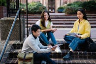 Photograph of a Group of Friends Sitting on Brick Steps
