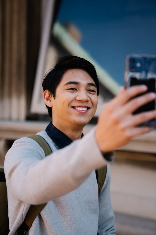 Free Man Smiling While Taking Selfie Stock Photo