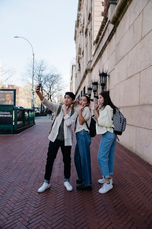 Three People Taking a Group Selfie Together