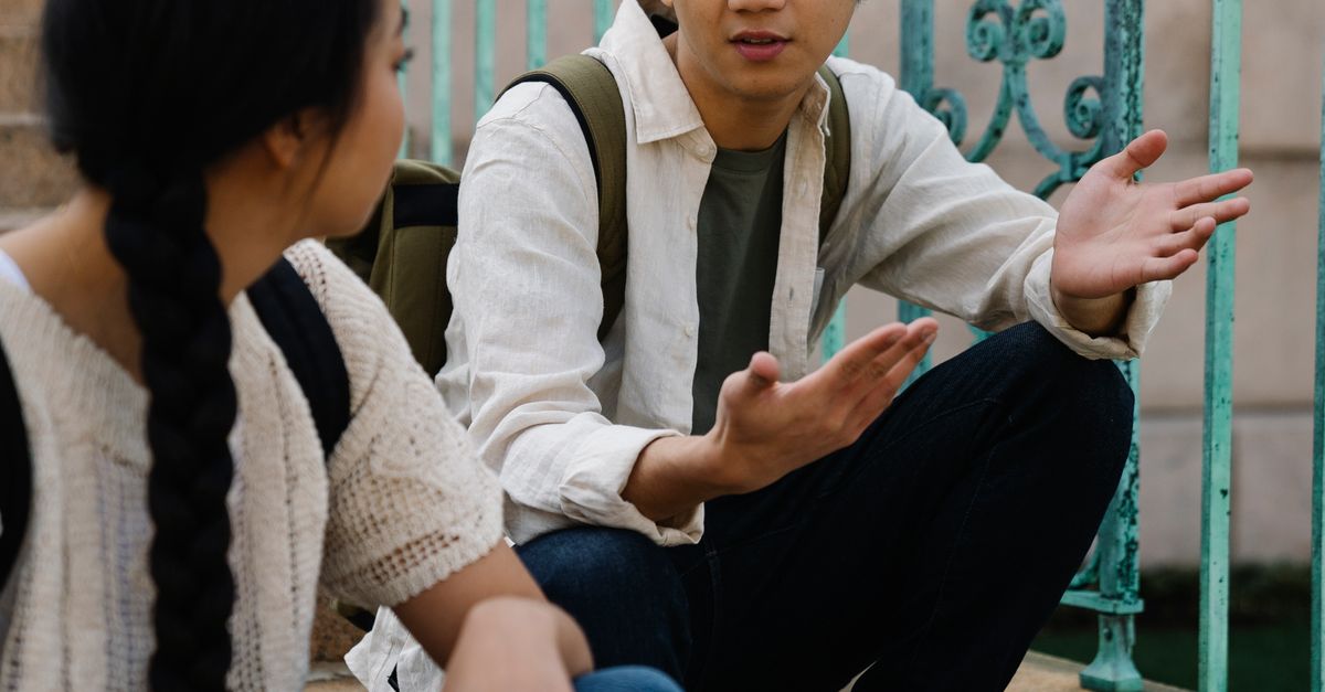 Explaning Things Photo of a Man Explaining to a Woman · Free Stock Photo
