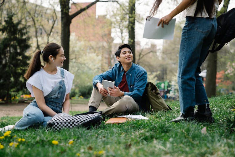 College Students Handing Out In A Park 