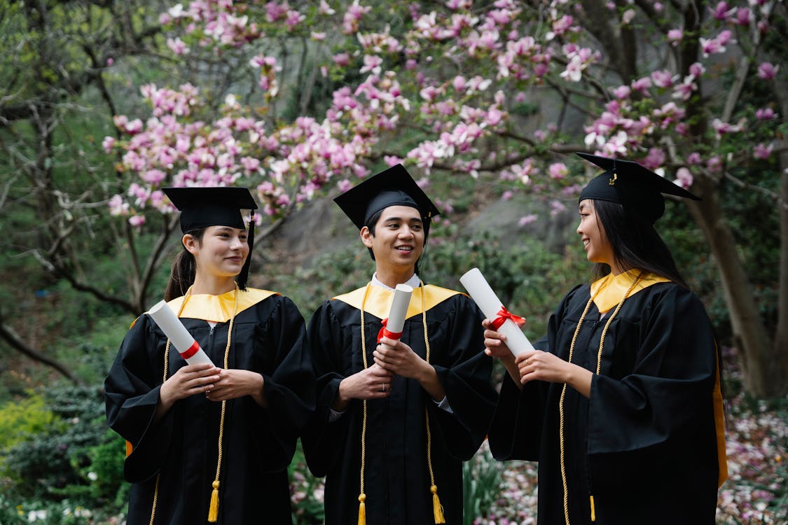 Happy Students with Diplomas in Garden · Free Stock Photo