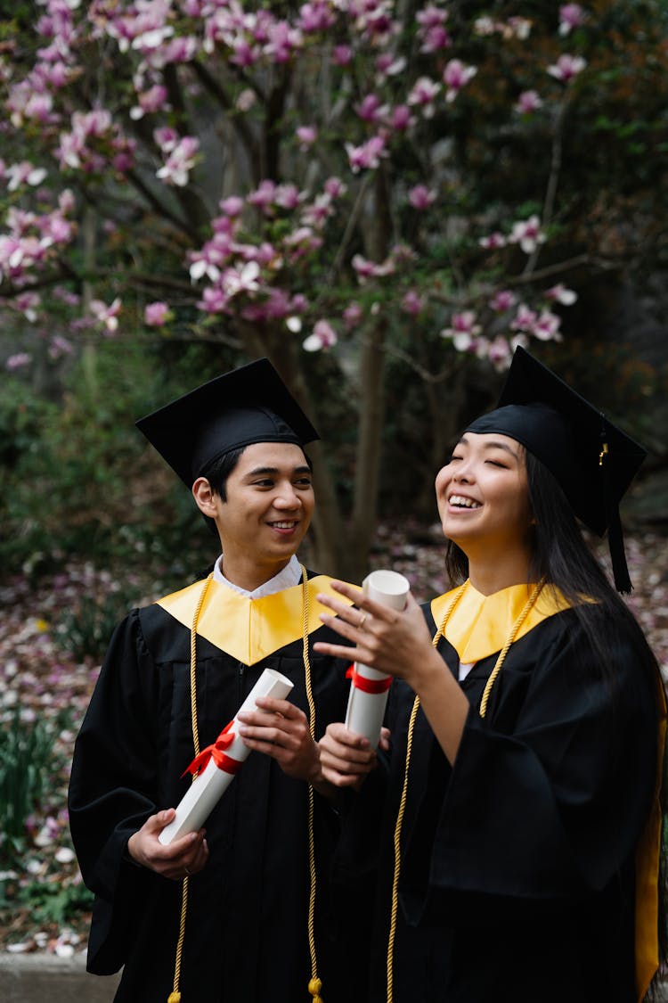 Students During Graduation Holding Their Diplomas 