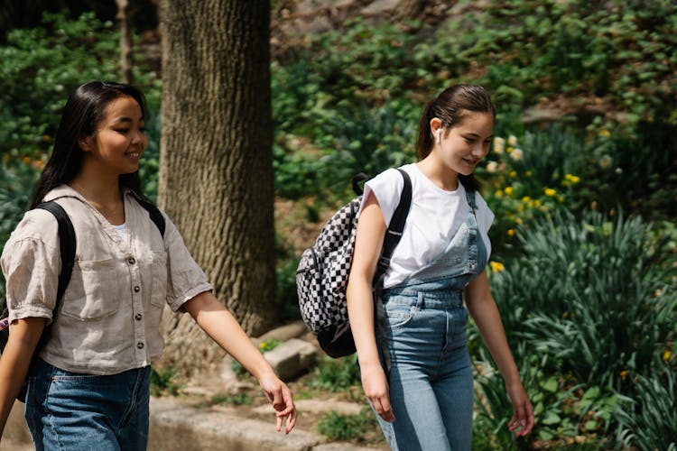 Two Teenage Schoolgirls Walking And Talking 