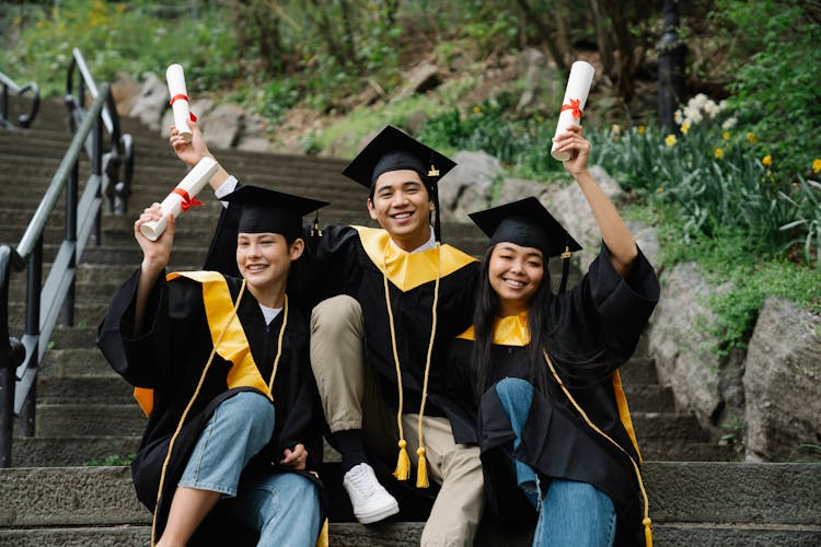 Graduates Holding Their Diplomas