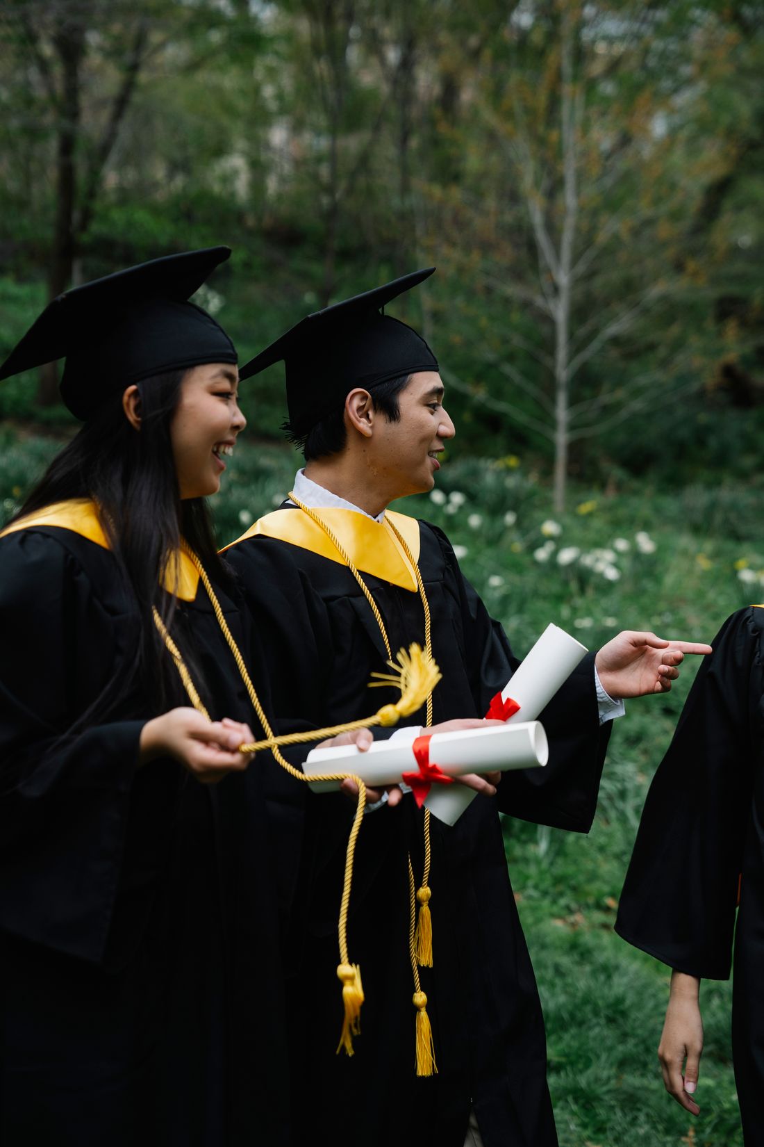 Graduates celebrating their postgraduate achievement outdoors