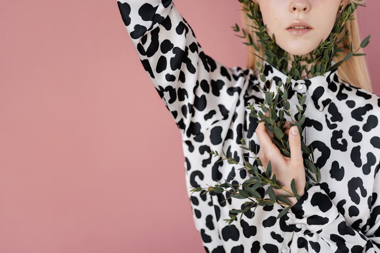 Woman With Plant Twigs Stuck Behind Her Animal Print Shirt 