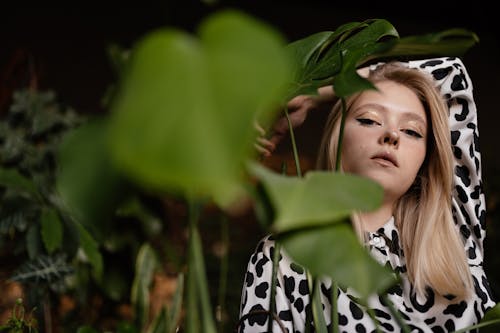 Woman in Leopard Print Shirt Near Green Plants 