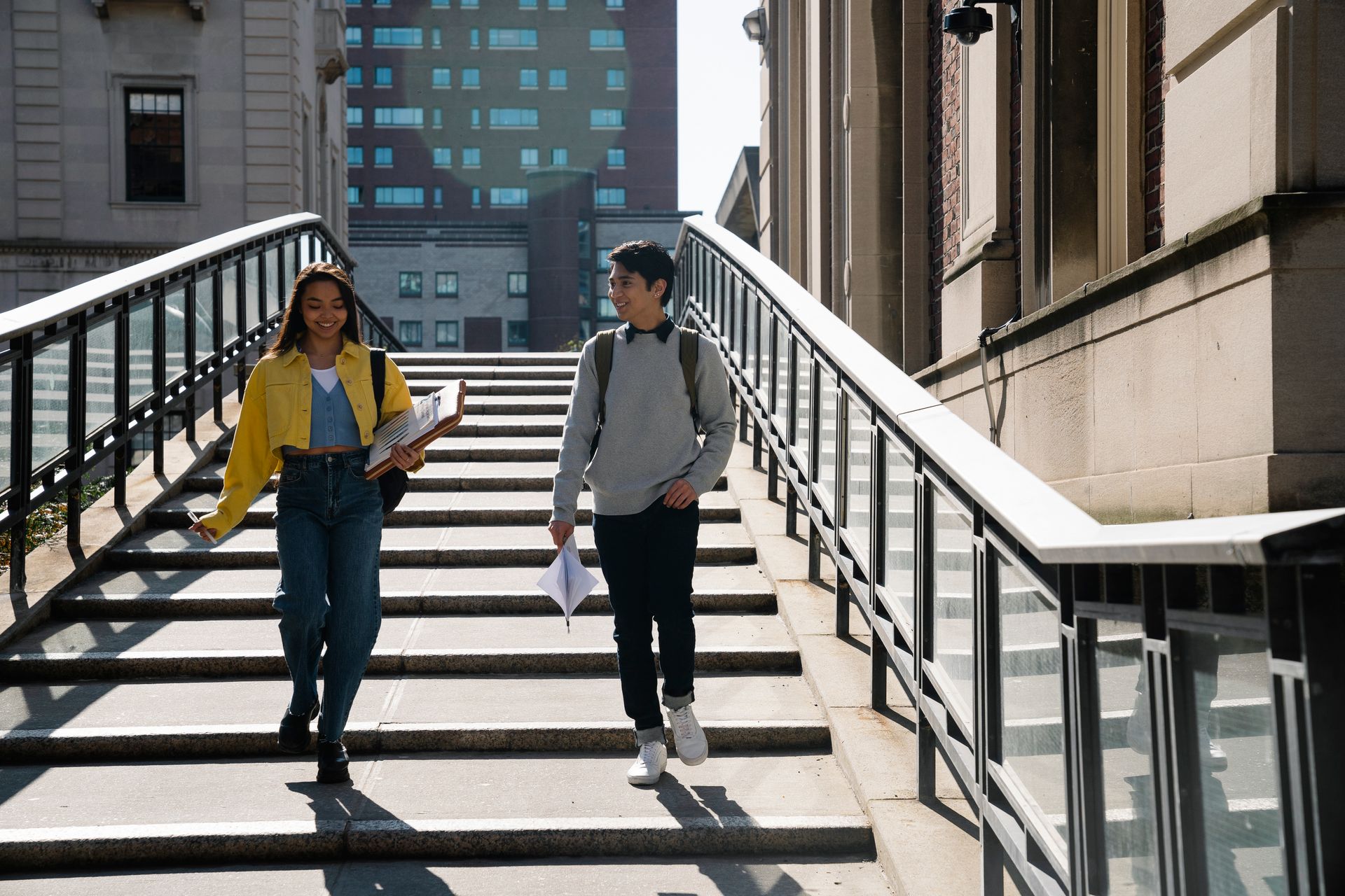 Two Students Talking While Walking Down an Outdoor Steps