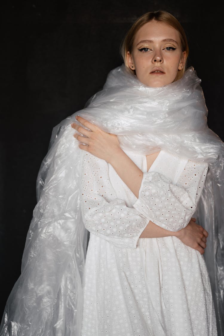 Woman In White Dress Wrapped In Plastic 