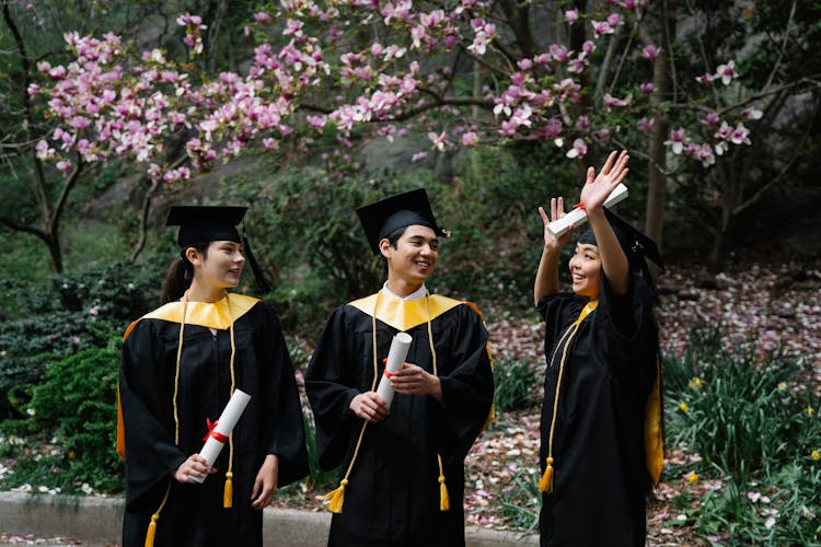 Victorious Former Students Wearing Graduation Gown 