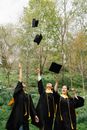 Woman in Black Academic Dress Holding Black Academic Hat