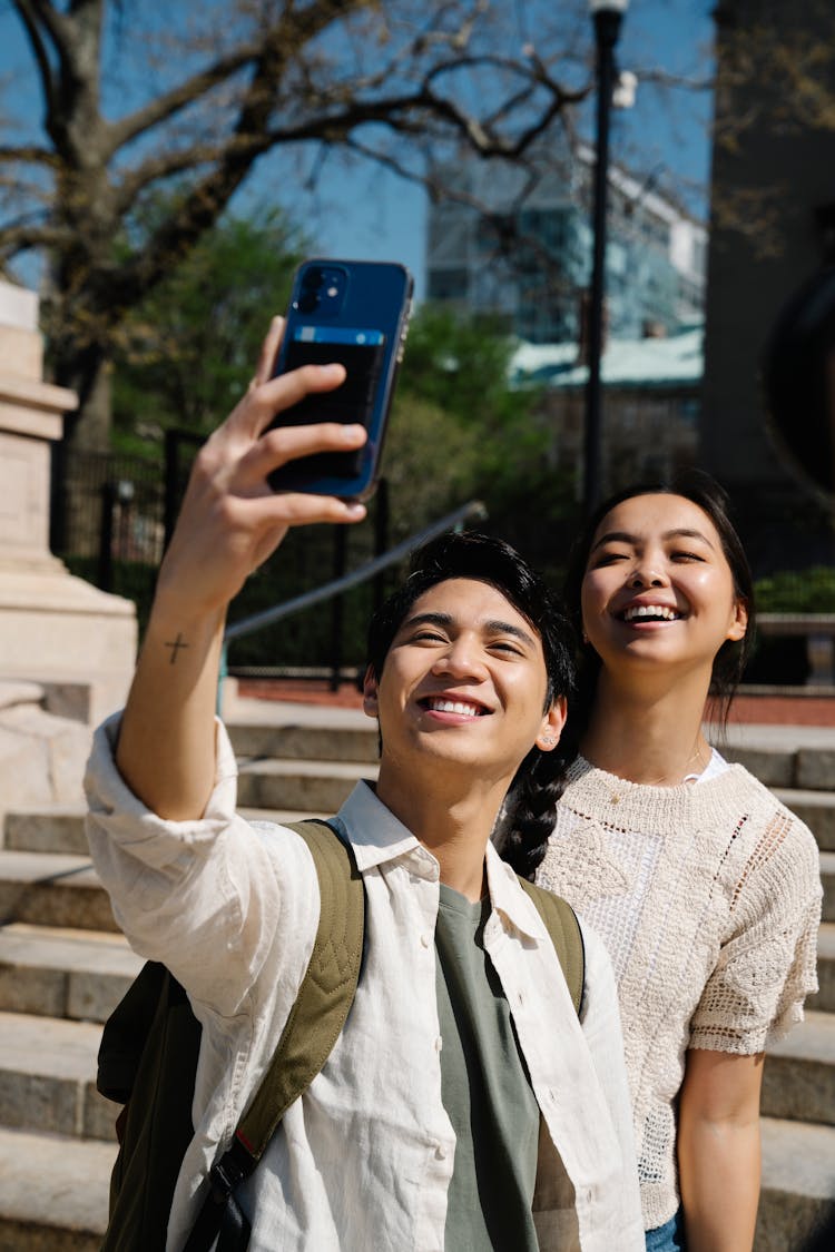 Boy And A Girl Taking A Selfie