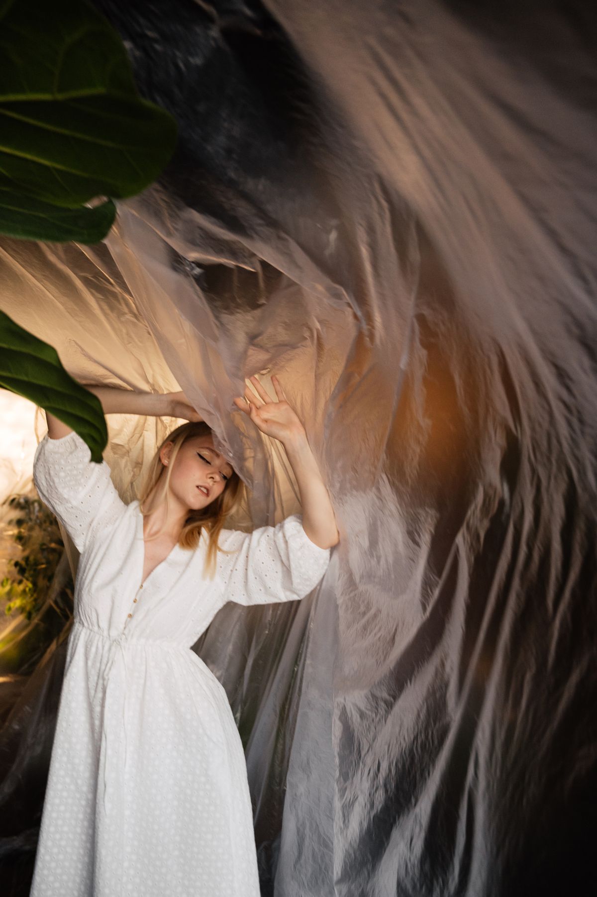 A woman in a flowing white dress in dreamy soft light — the fine-art editorial of summer dressing