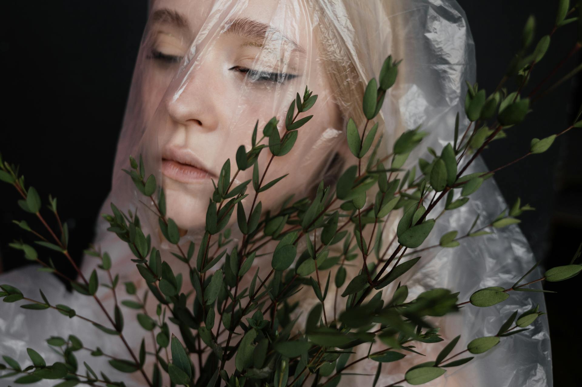 A Woman's Face Covered with Plastic Wrap