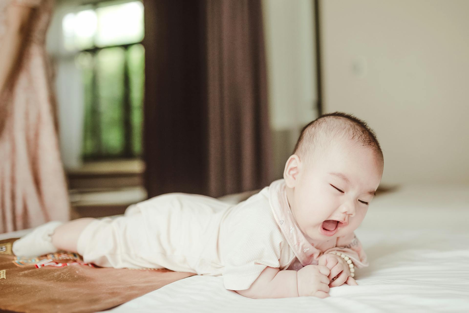 Cute Asian newborn baby lying on white blanket