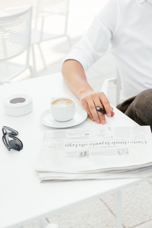 Free A morning coffee with a newspaper at an outdoor cafe, captured in a lifestyle setting. Stock Photo