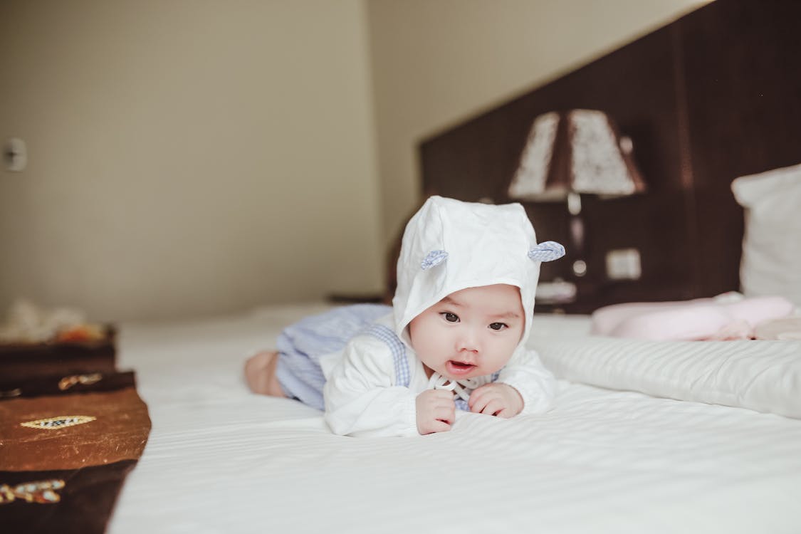 Free Sweet adorable infant lying on soft blanket Stock Photo