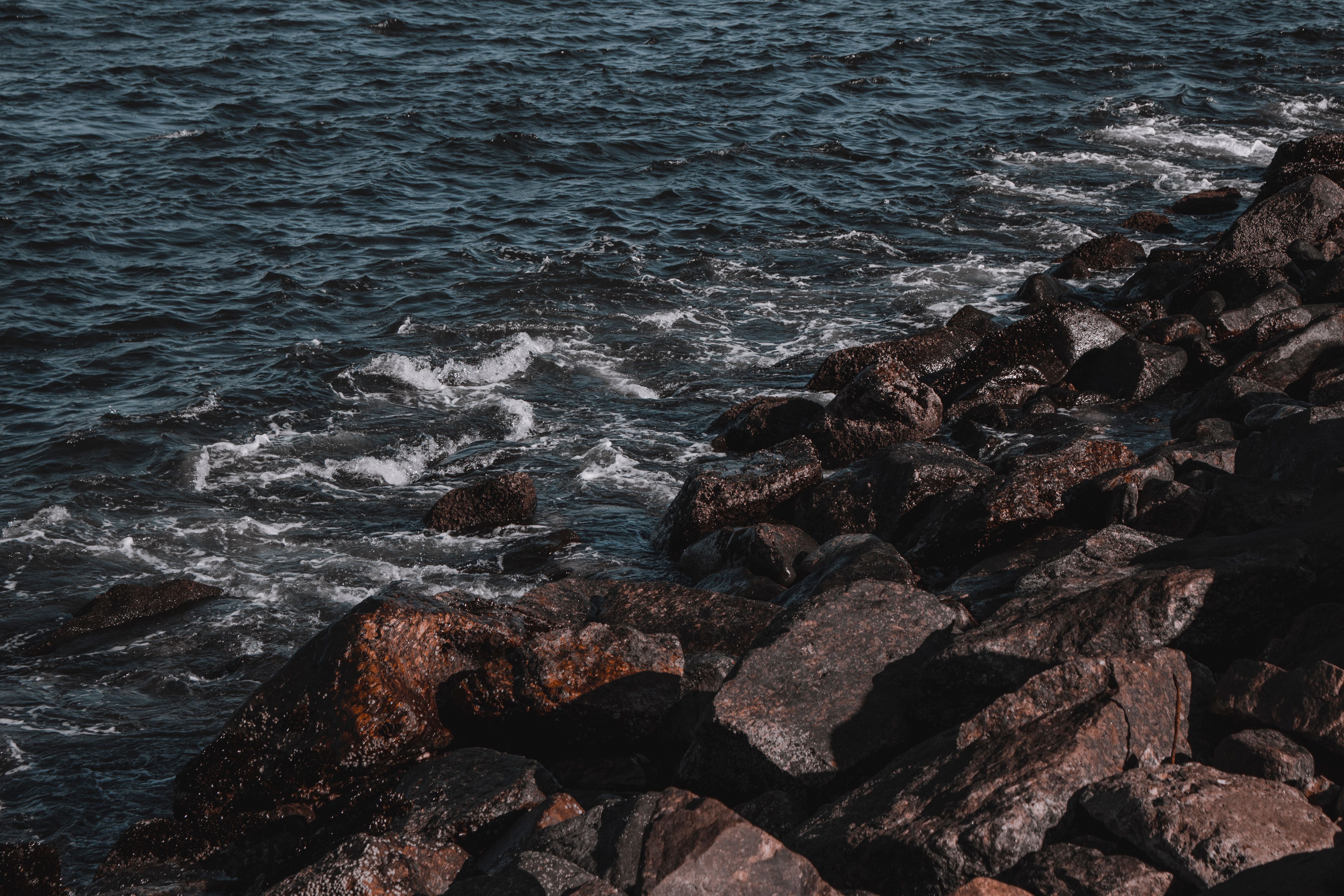 Brown Rocks Near Body of Water · Free Stock Photo