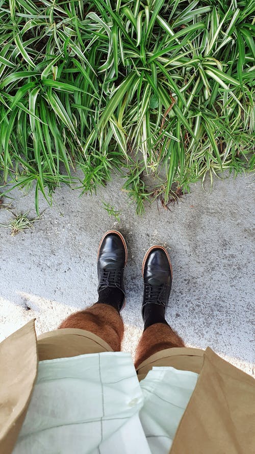 Person in Brown Pants and Black Leather Shoes