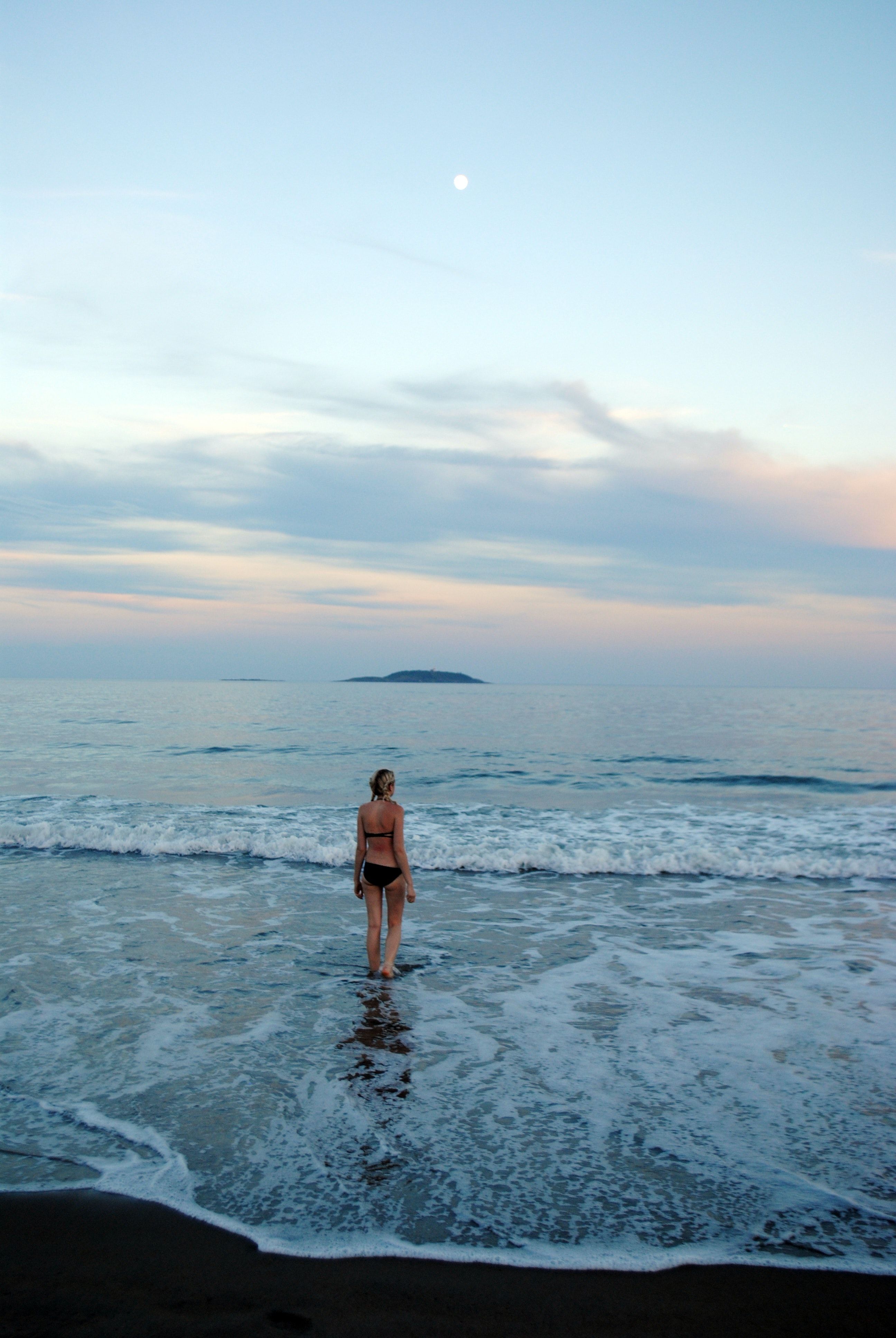 Woman in Black Bikini Standing on Seashore · Free Stock Photo