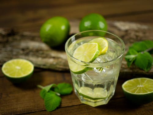 Selective Focus Photo of a Drinking Glass with Lime Juice