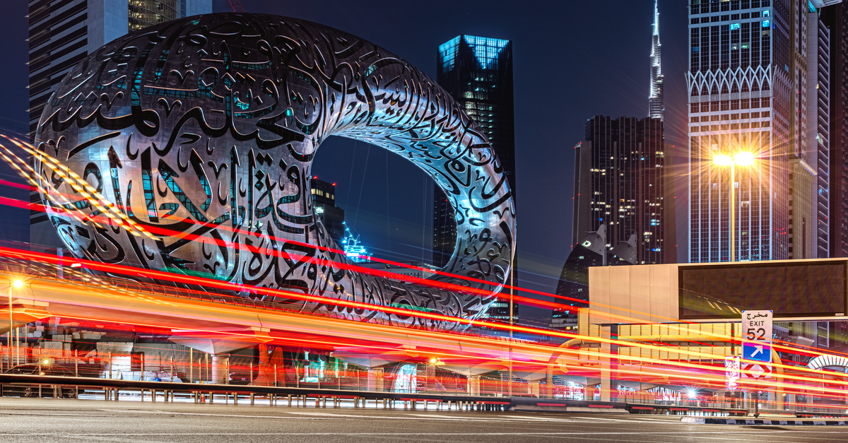 Long exposure of Dubai's Museum of the Future and skyline, showcasing architecture and light trails