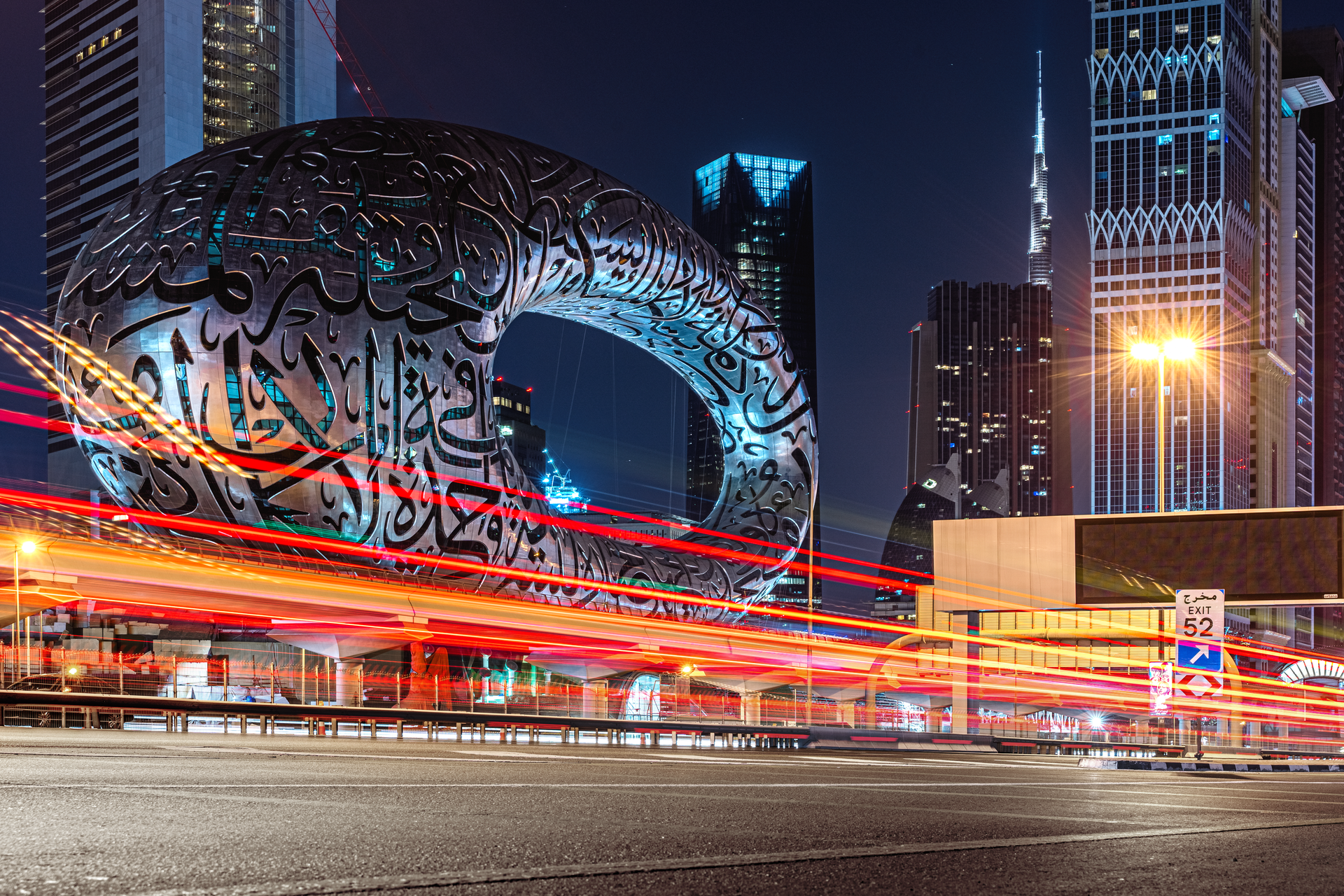 Long exposure of Dubai's Museum of the Future and skyline, showcasing architecture and light trails