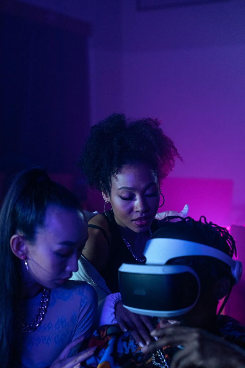 Three women immerse themselves in virtual reality, sharing an exciting indoor experience.