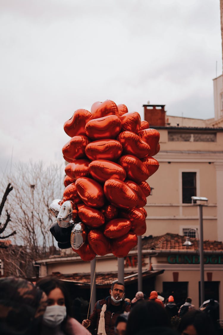 A Man Selling Heart Shaped Balloons 