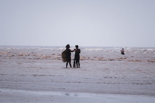 Man and Woman Standing on Beach