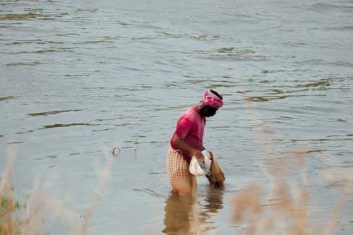 A Fisherman with a Net in the Lake