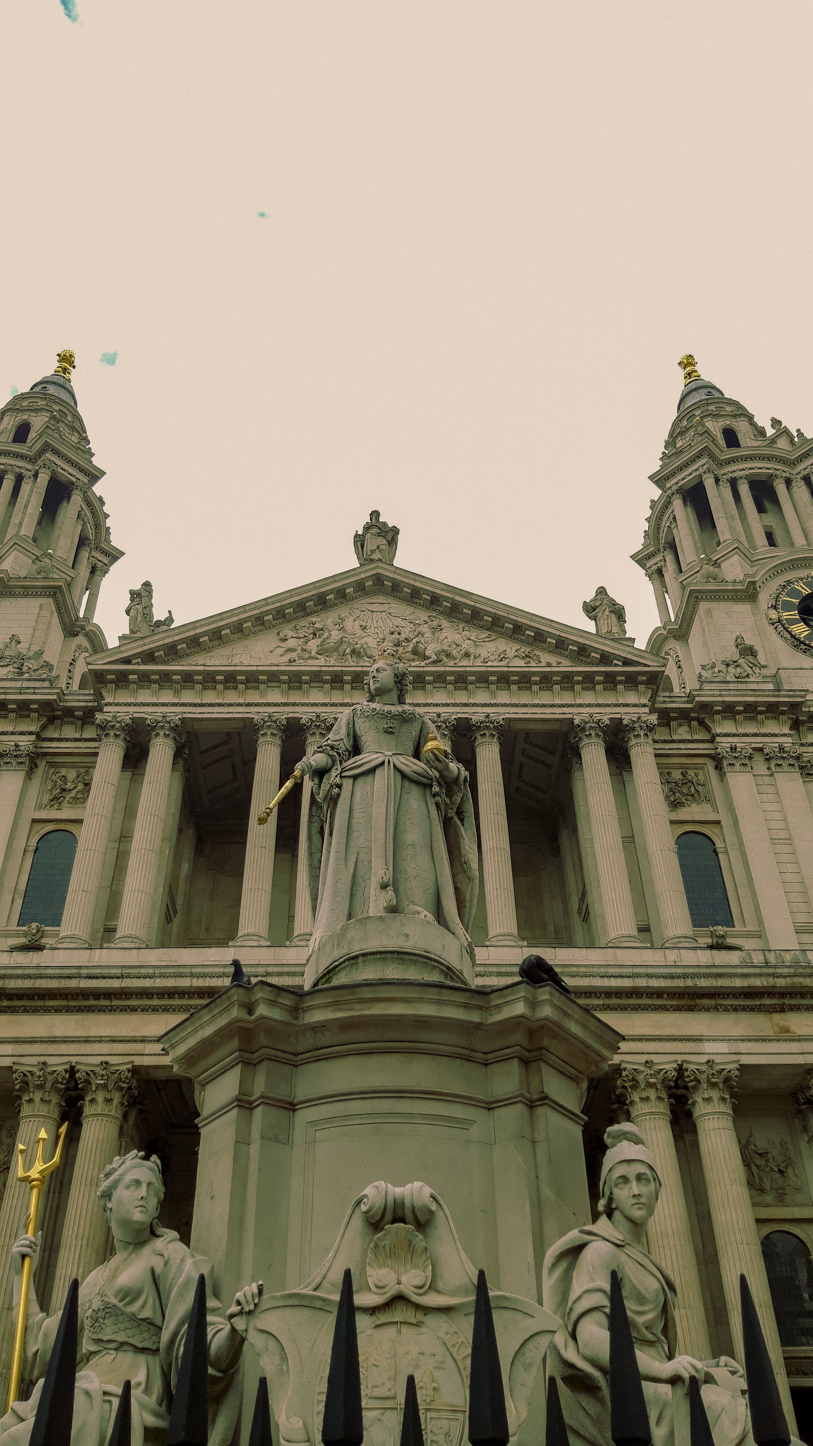 Stunning low-angle shot of St. Paul's Cathedral facade with statues and architectural details.