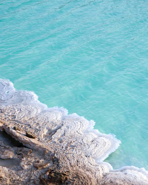 Free Close-up view of salt formations by turquoise waters in Abu Dhabi, United Arab Emirates. Stock Photo